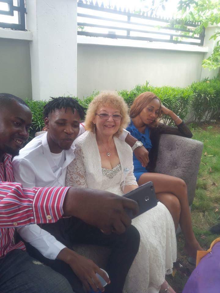 Young Nigerian man shows off his old white bride (Photos)