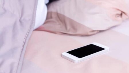 Here's why sleeping with your phone in bed can affect your health