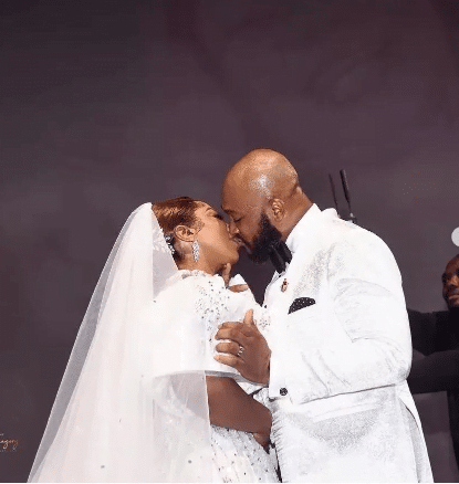 Blossom Chukwujekwu and Winifred Akhuemokhan passionately kiss on the wedding altar