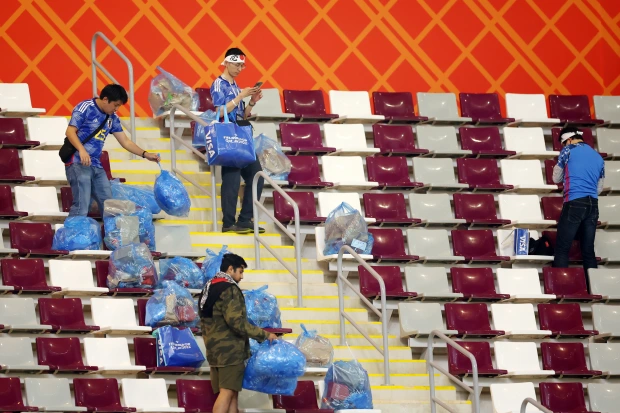 Japanese supporters tidy up stadium
