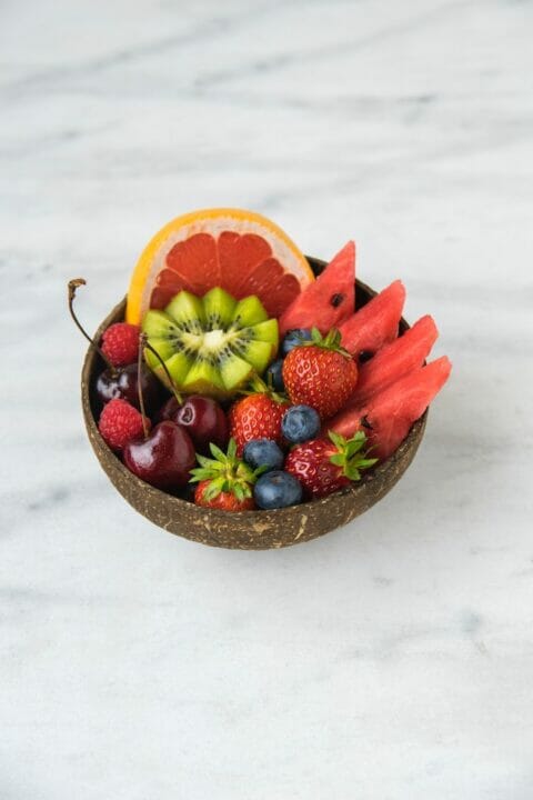 A colorful assortment of fresh fruits on a wooden table.