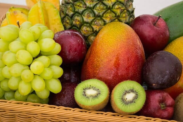 A colorful assortment of fresh fruits on a wooden table.