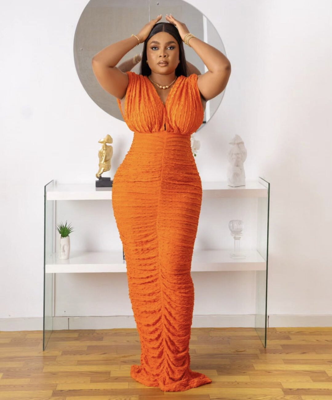 Bimbo Ademoye in a lovely orange dress that is suited for wednesdays.