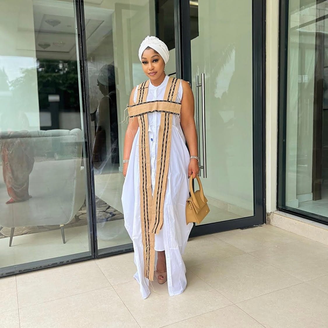 Rita Dominic displaying the importance of color combination in a rich and classy white and brown outfit.