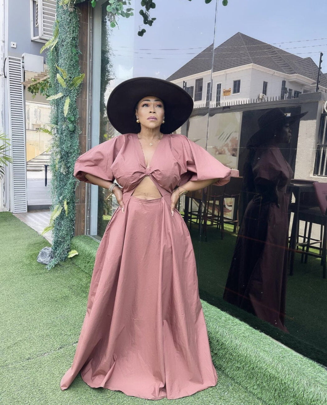 Shaffy Bello in a maxi dress with a cut out in front.
