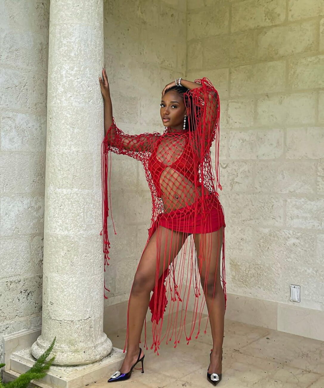 Fierce and bold: Ayra Starr slays in a red two piece outfit.