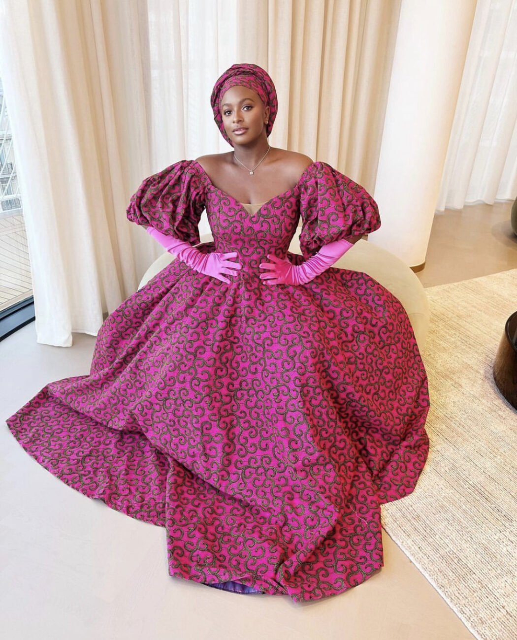 Dj Cuppy in a pink Ankara outfit.