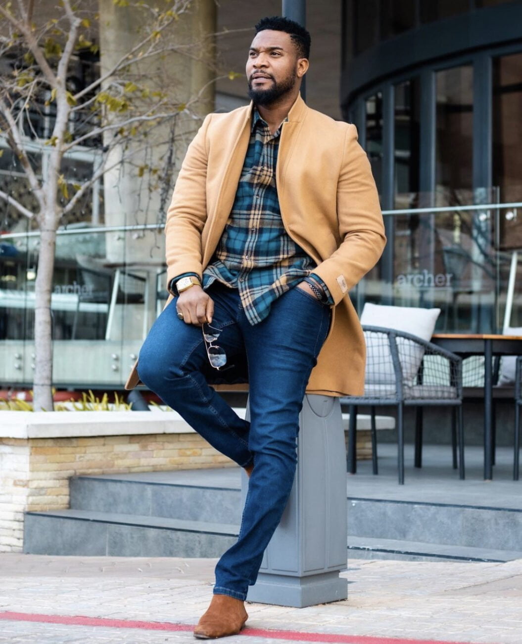 Elegance personified as Kunle Remi rocks bvrown coat, flannel shirt, denim trousers and suede shoes.