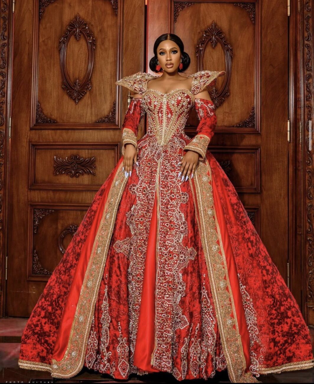 Mercy Eke in a regal looking red dress.