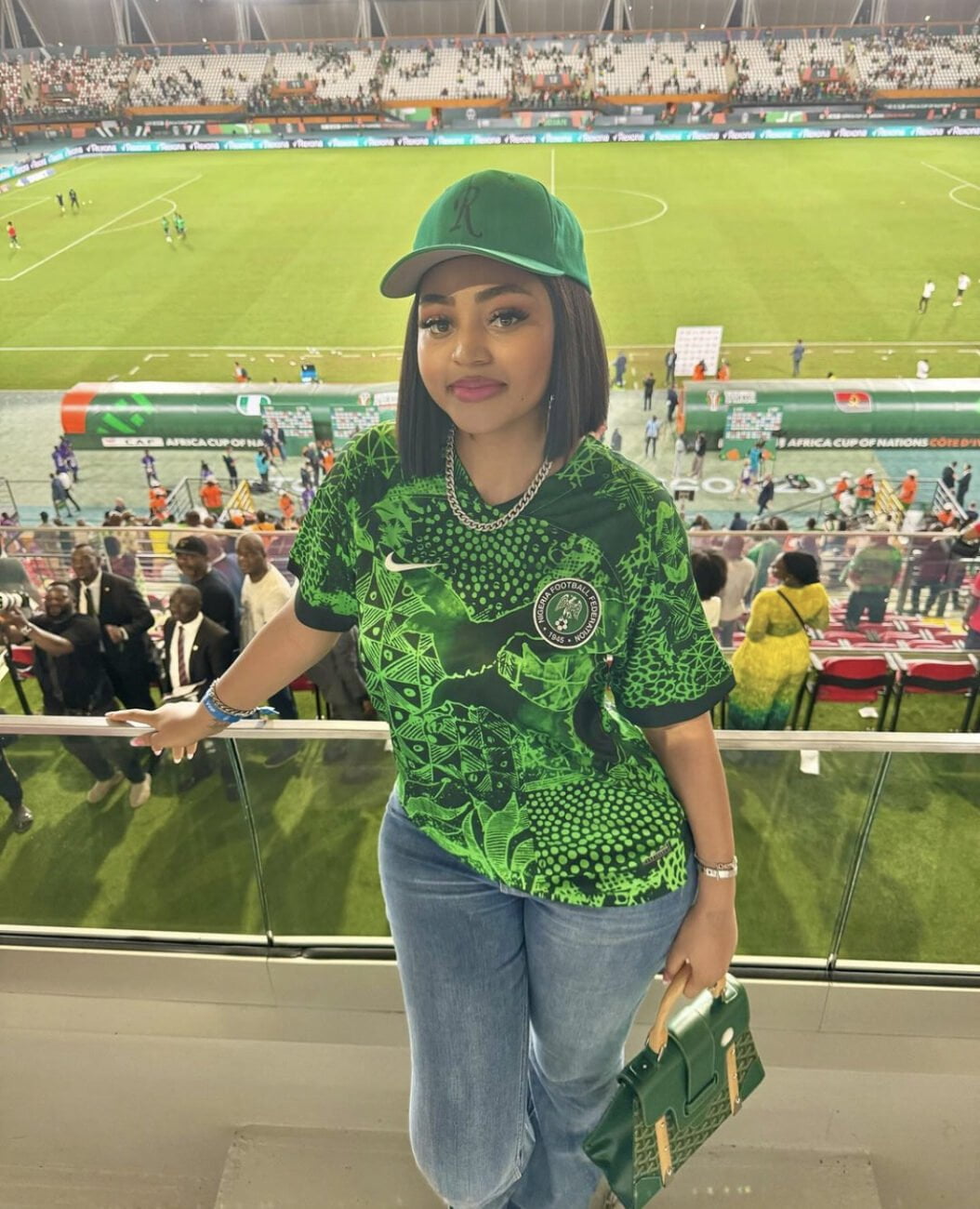 Regina Daniels pictured in a Nigerian jersey at an AFCON match.