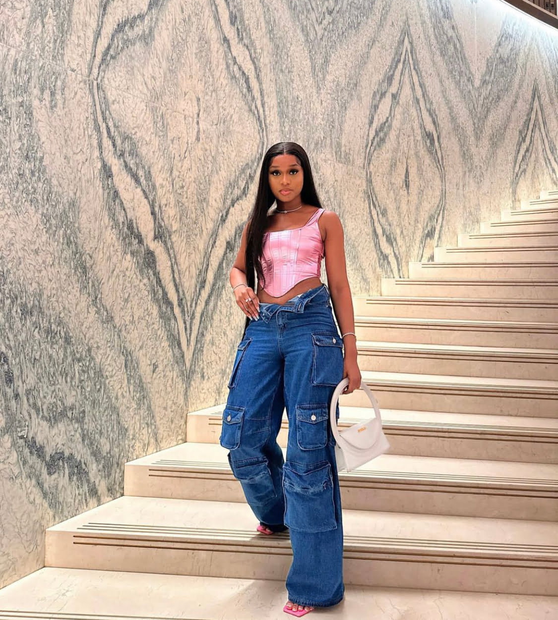 Frances Theodore in a pink corset top and denim combat trousers.