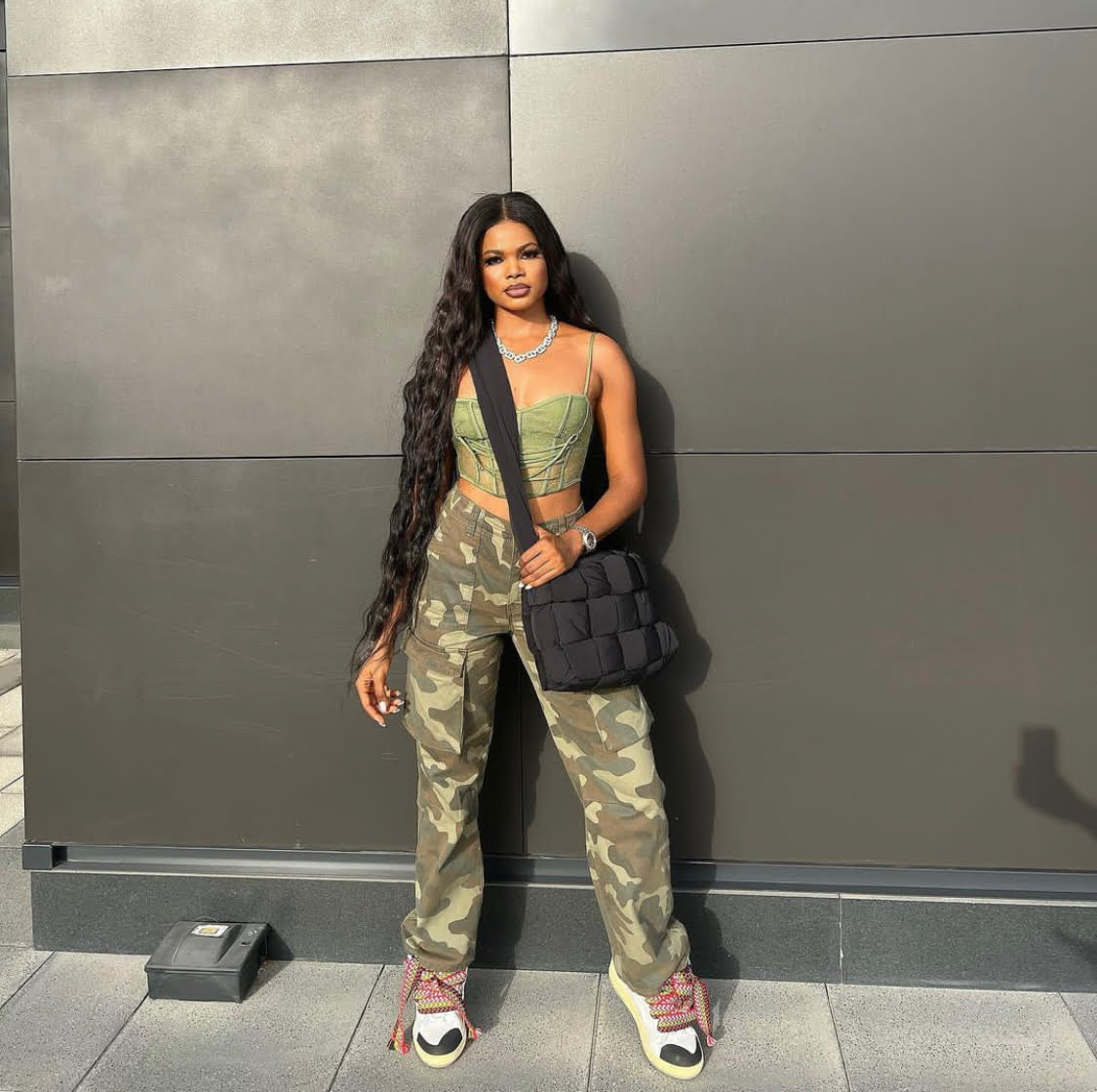 Boluwatife in army green combat trousers and a crop top.