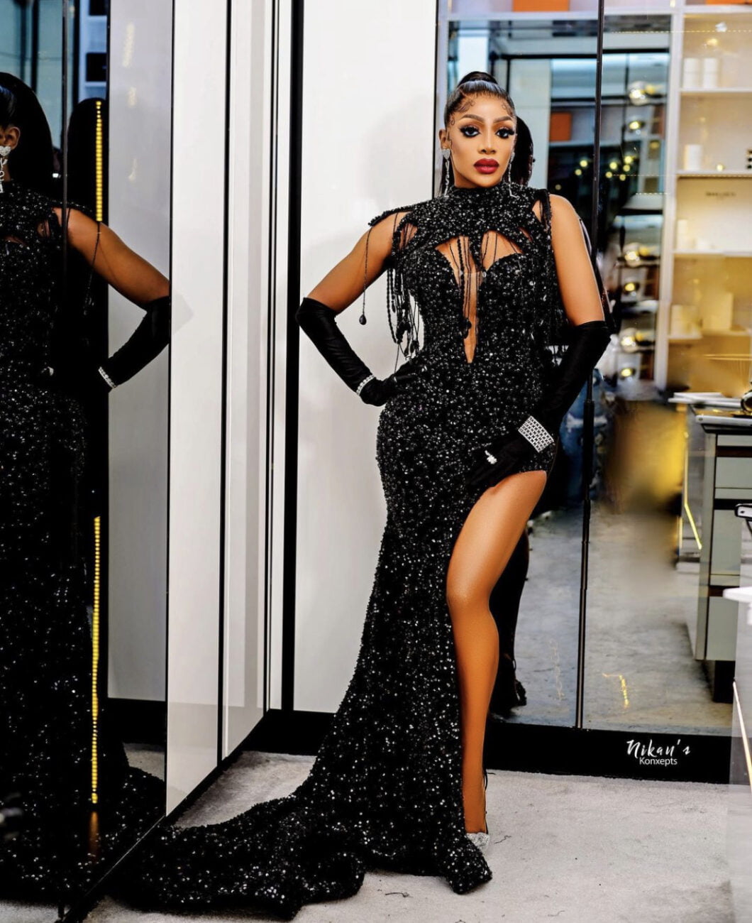 Chioma Good Hair in a bedazzled black dress with matching gloves.