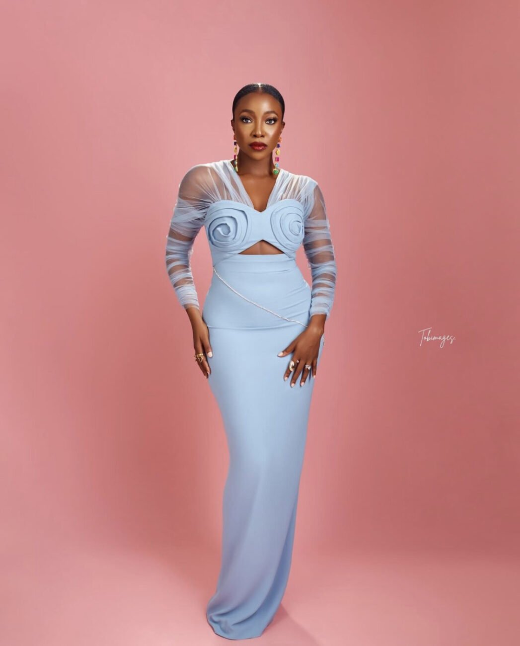 Ini Dima-Okojie in a lovely blue dress with mesh sleeves.