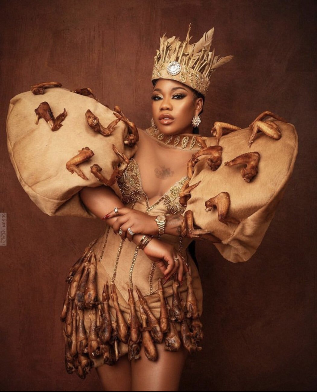 Toyin Lawani in a dress made out of fried chicken. 