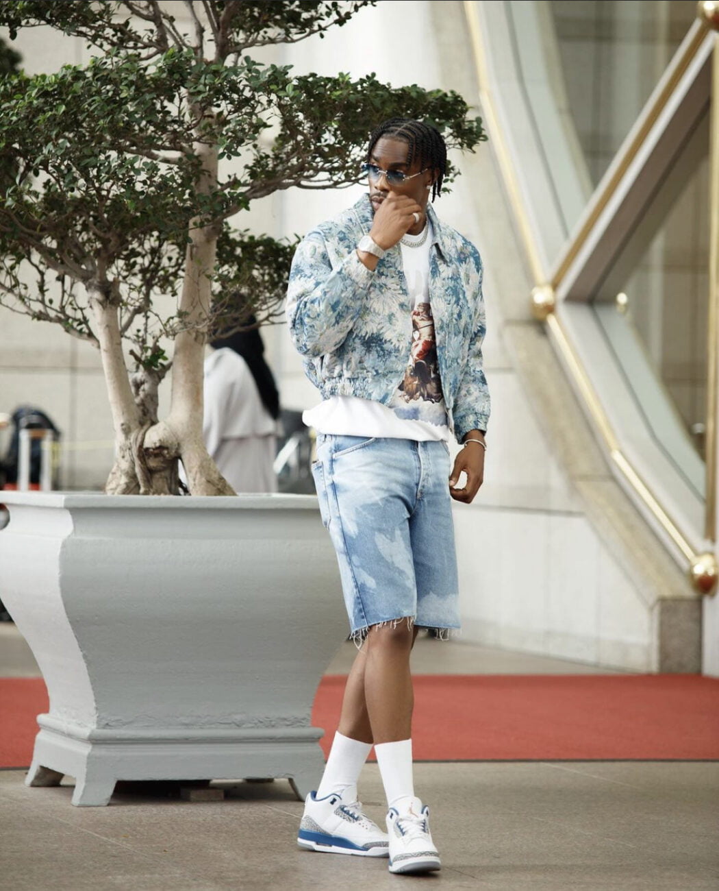 Neo Akpofure in a denim jacket, paired with denim shorts.
