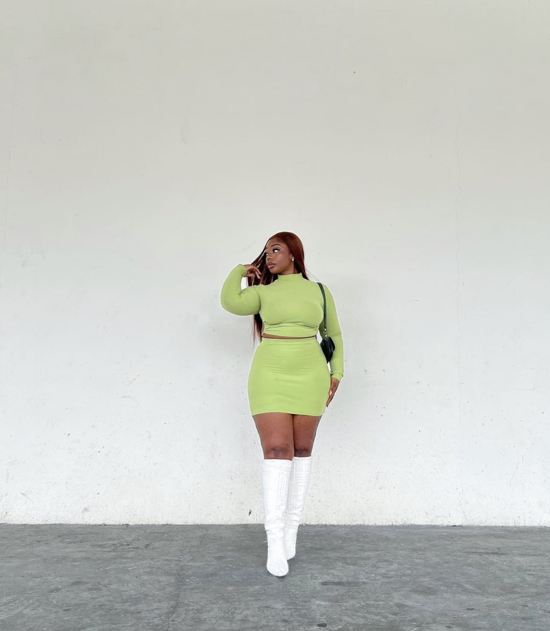 Neon green two piece outfit, paired with white boots.
