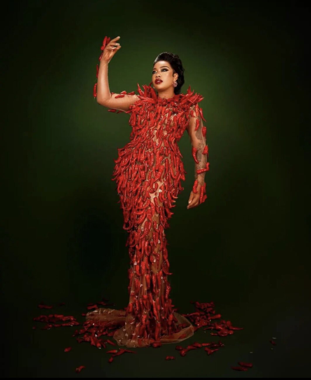 Toyin Lawani in a dress made out of pepper fruits.