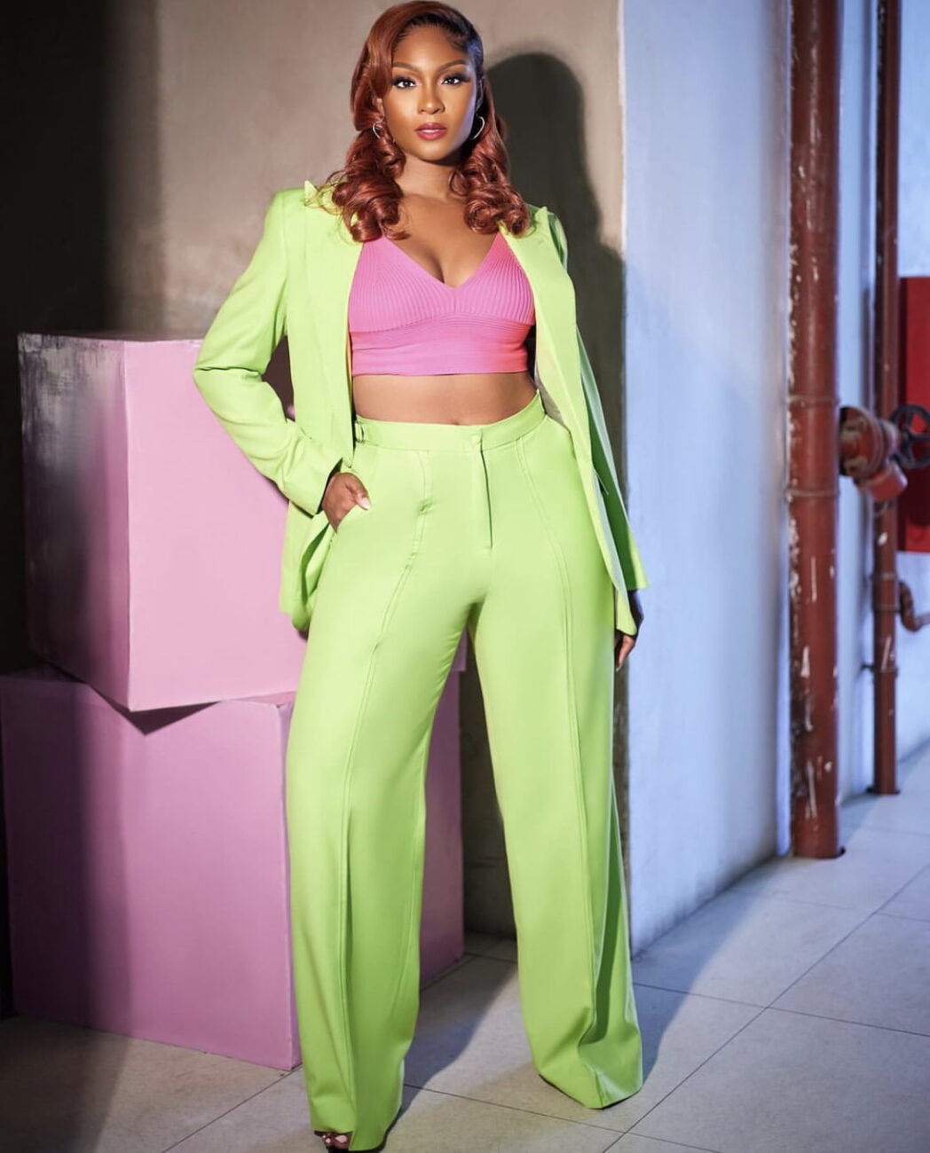 Osas Ighodaro in a neon green suit.