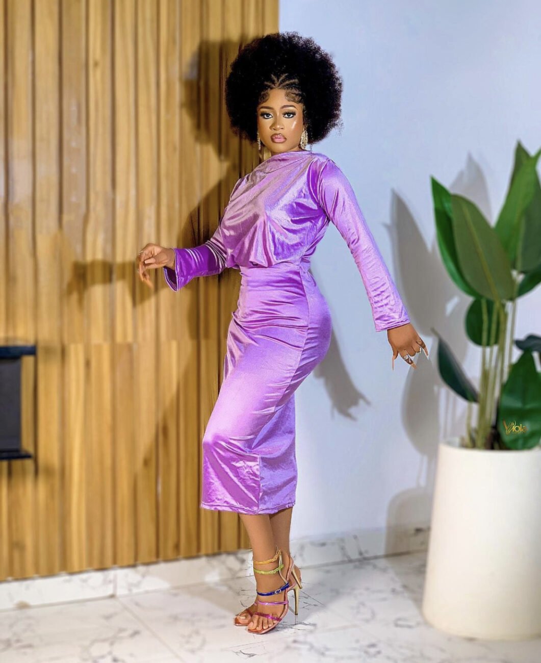 Phyna in a purple satin two piece outfit.
