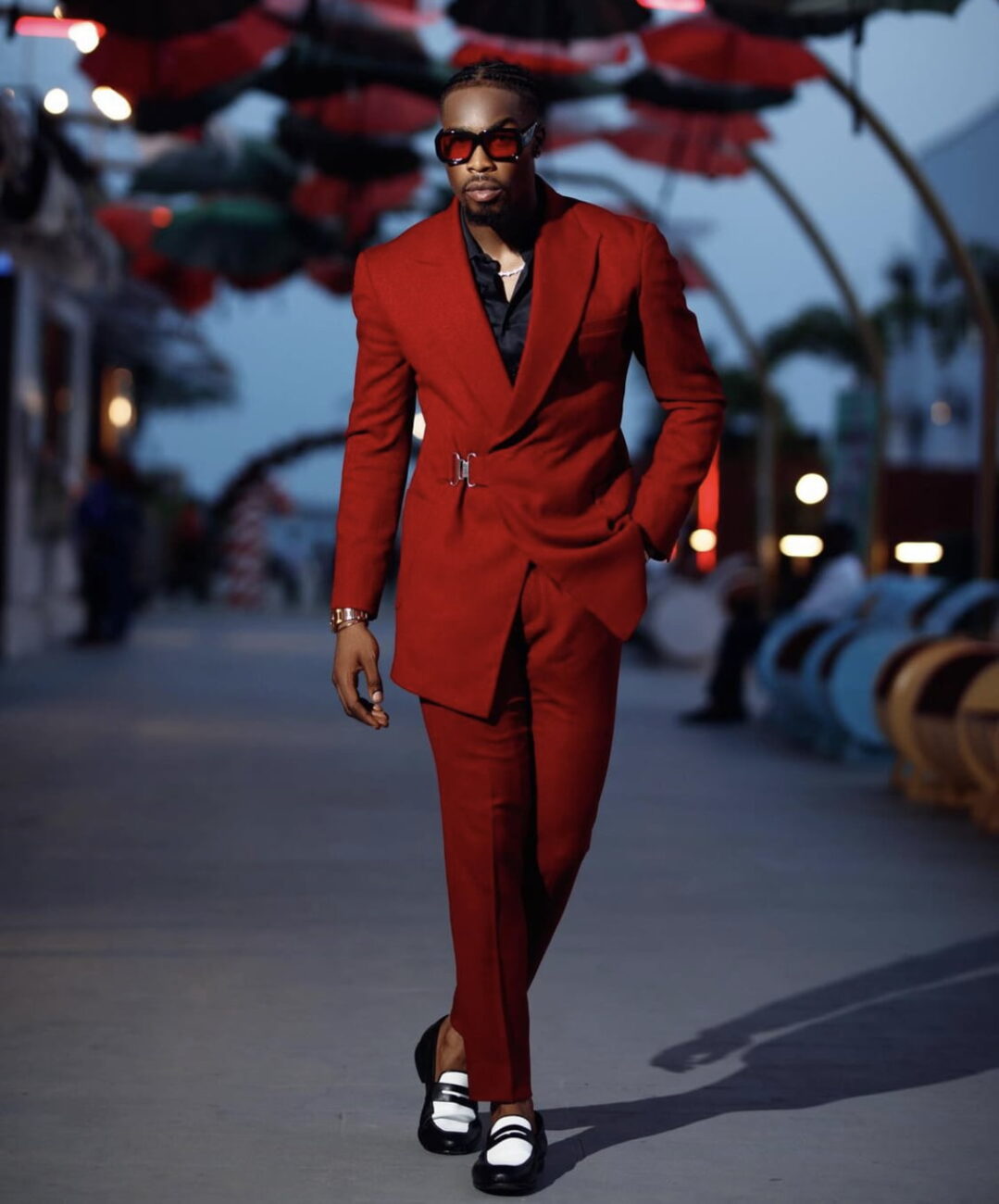 Neo Akpofure in a red suit.