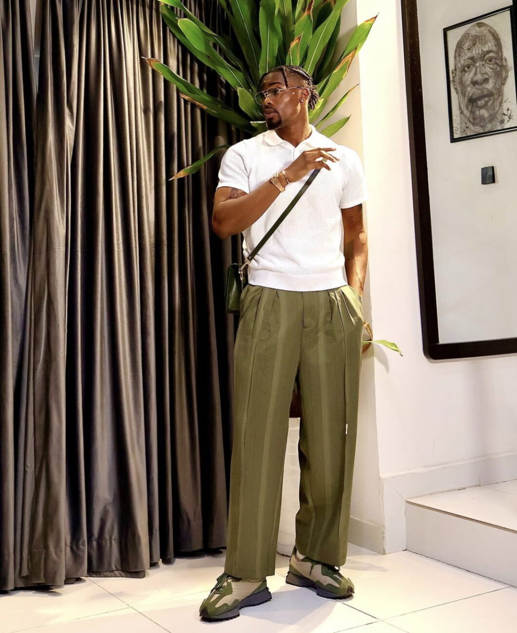 Neo Akpofure in a white shirt and green trousers.
